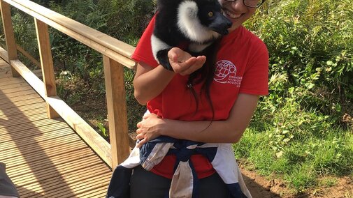 EWB-NU volunteer with a lemur on her shoulder in Madagascar
