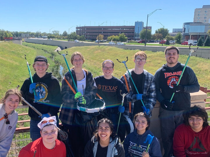 EWB-NU members posing with trash bags after twice annual stream cleanup