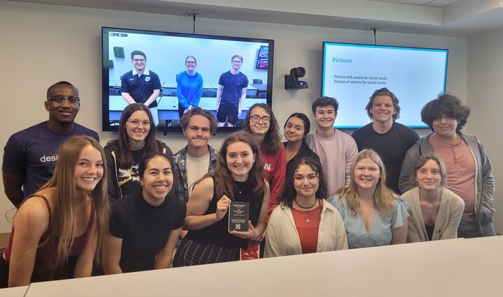 EWB-NU accepting the University Program of the Year Student Impact Award 