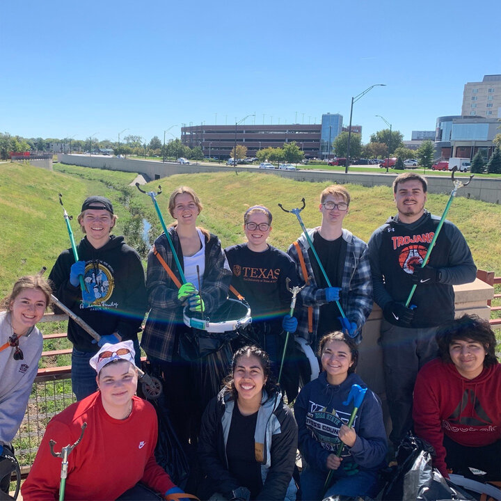EWB-NU members posing with trash bags after twice annual stream cleanup